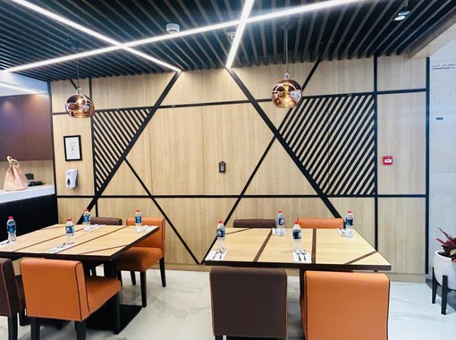 ELEV&Eacute; restaurant interior with bespoke dining furniture and modern lighting